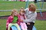 Children sitting on barrel