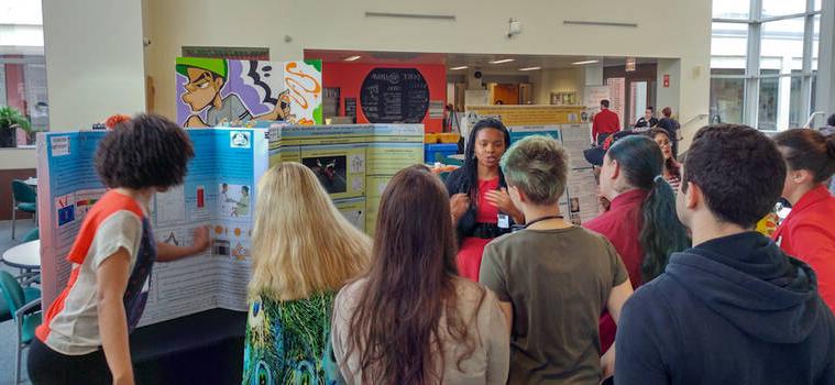 Presenter speaking to students about her research.