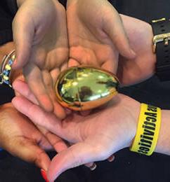 Student hands holding the lucky golden egg