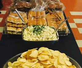 Chips, rolls and mac salad on a table