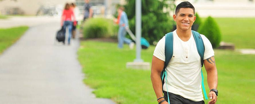 Photo of male student walking outside